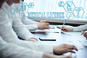 physicians around a table, with the text Medical License overlaying the image