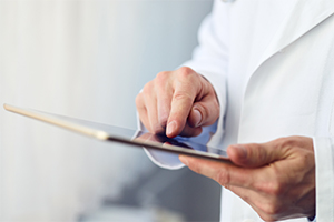 physician holding a digital tablet